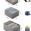 A gray foldable drawer organizer with multiple compartments for storing undergarments and accessories.