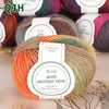 A ball of rainbow colored wool yarn labeled Rainbow Yarn MX002 for knitting and crocheting