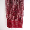 A close-up of decorative door string curtains in a deep red color hanging vertically.