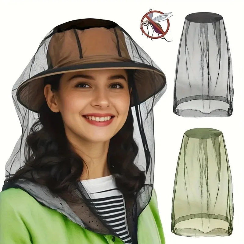 A woman smiling while wearing an extra large mosquito net with a face mask over her head.