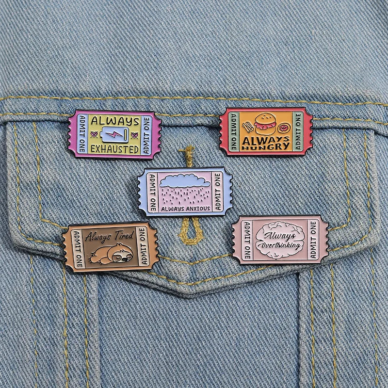 A set of vintage enamel lapel pins featuring various humorous phrases like Always Exhausted, Always Hungry, and Always Anxiou