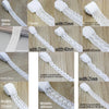 Various widths of white cotton embroidered lace trim rolls shown in close-up detail.