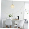 A white modern dining table with two white chairs and a pendant light fixture above it.