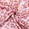 Pink leopard print satin fabric draped in soft folds