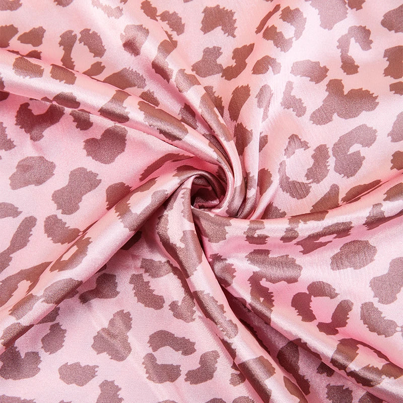 Pink leopard print satin fabric draped in soft folds