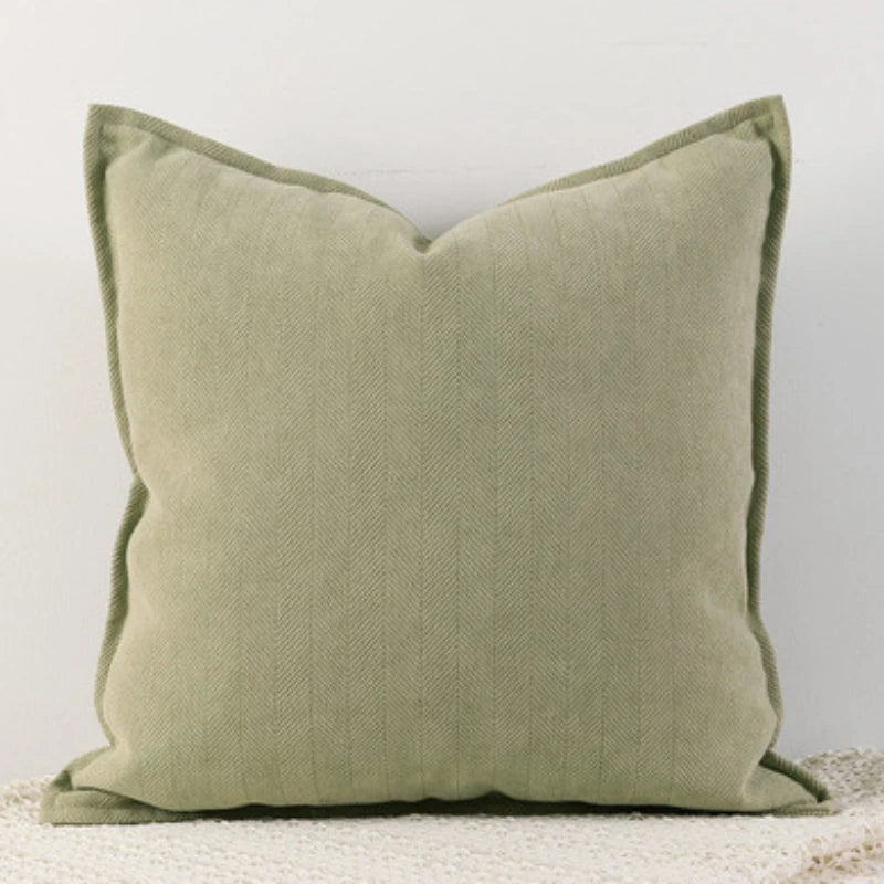 A solid sage green chenille throw pillow cover with a subtle vertical texture.