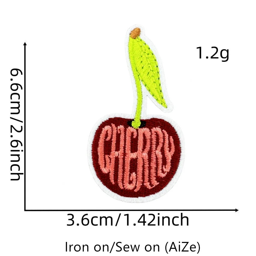A yellow cherry fruit patch embroidered on a white background, measuring 1.2g.