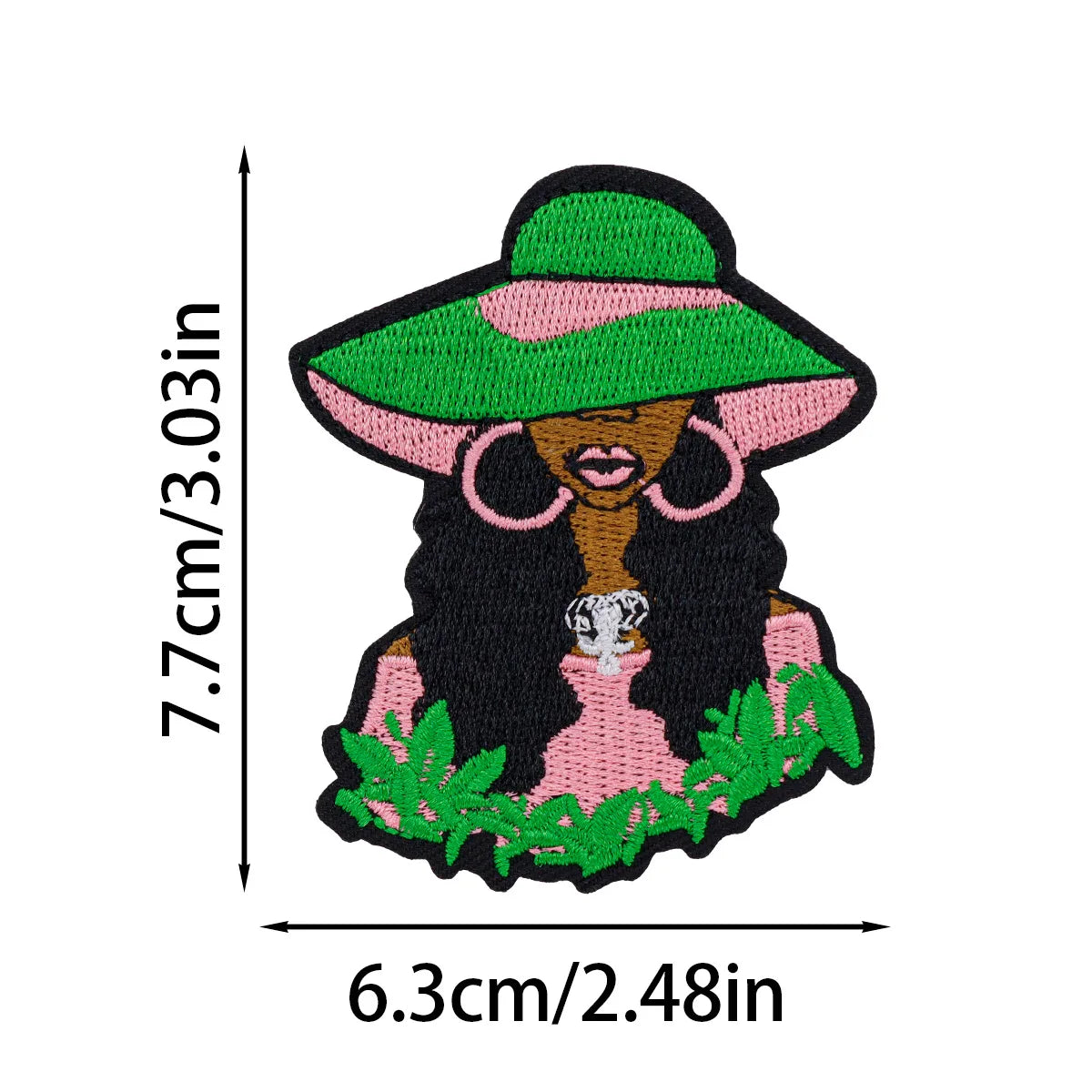 Embroidered patch featuring a cartoon woman with long dark hair wearing a green hat and pink clothing.
