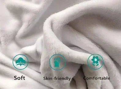 A close-up of a white, soft fleece throw blanket being draped and folded.