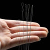 A hand holds a set of fine, silver-colored precision beading needles for jewelry making.