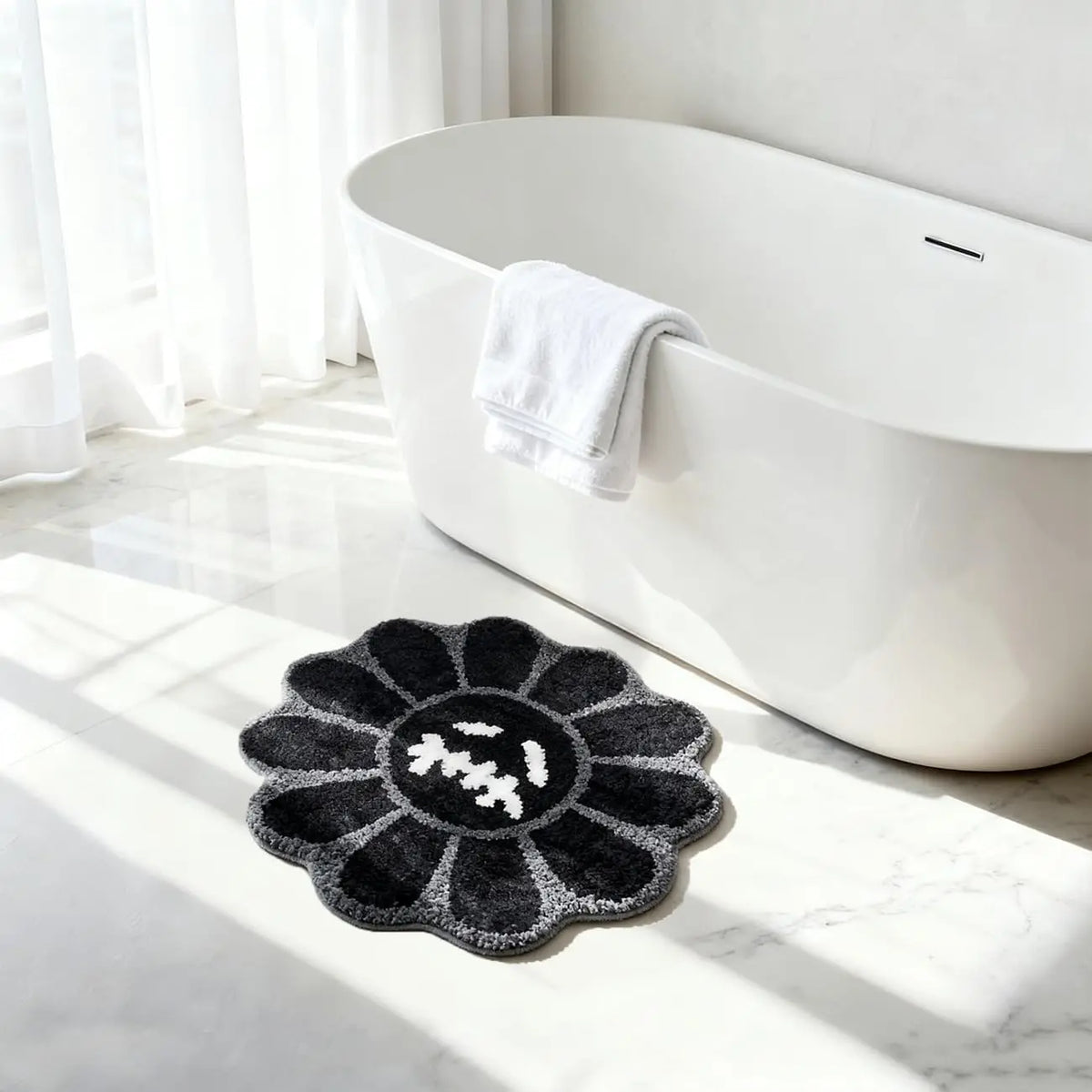 A black gothic sunflower absorbent non-slip bathroom mat placed on a white marble floor near a modern white bathtub.