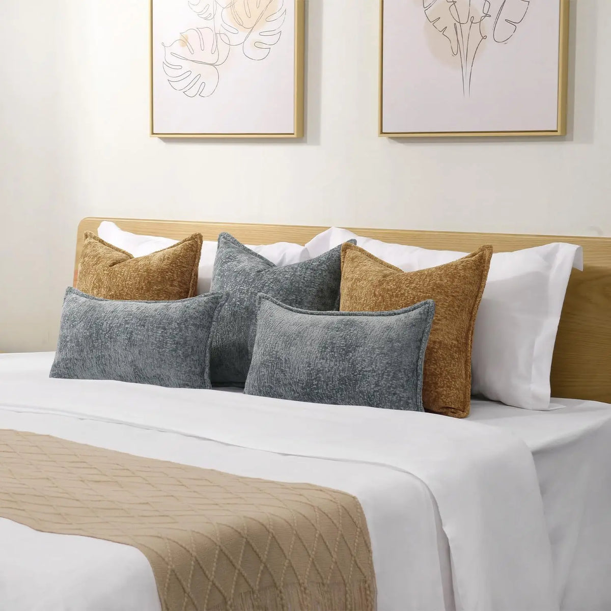 A collection of decorative chenille throw pillow covers in shades of gray, beige, and olive green on a white bed.