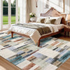 A rectangular area rug featuring a patchwork design of brown, blue, gray, and beige tones.