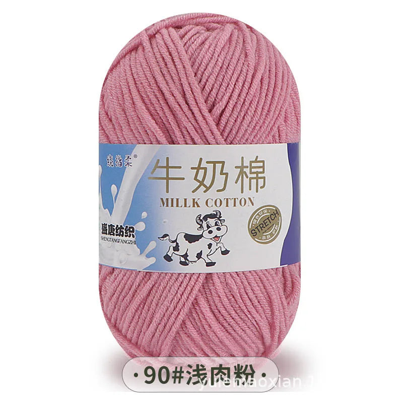 A ball of pink milk cotton yarn labeled in Chinese and English.