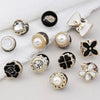 A collection of instant removable pearl brooch buttons in various sizes and designs, including floral and geometric shapes.
