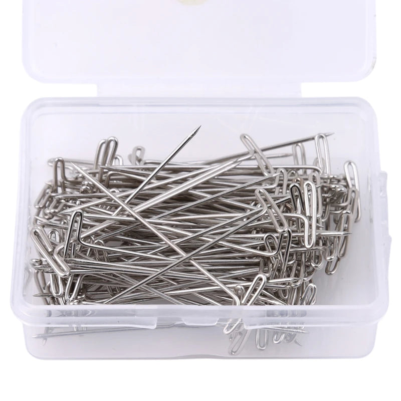 A clear plastic container holds a bundle of stainless steel T-pins for wig making or knitting.