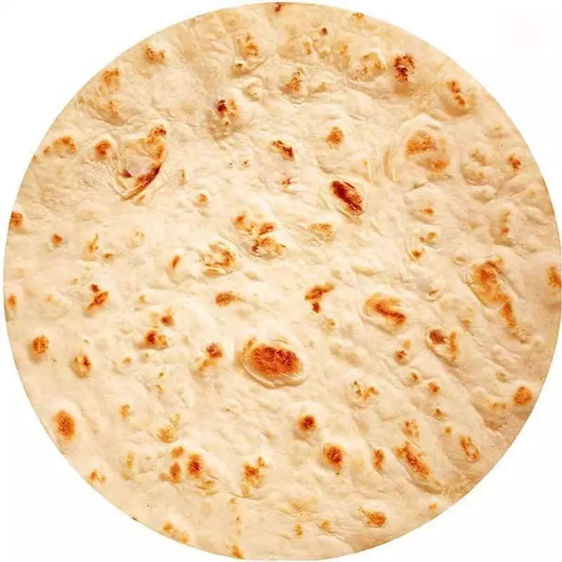 A round, light-colored flatbread or naan bread with browned spots.