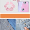 A collection of fabric items and metal snap buttons for a DIY sewing kit, including a yellow hoodie, pink shirt, and various 