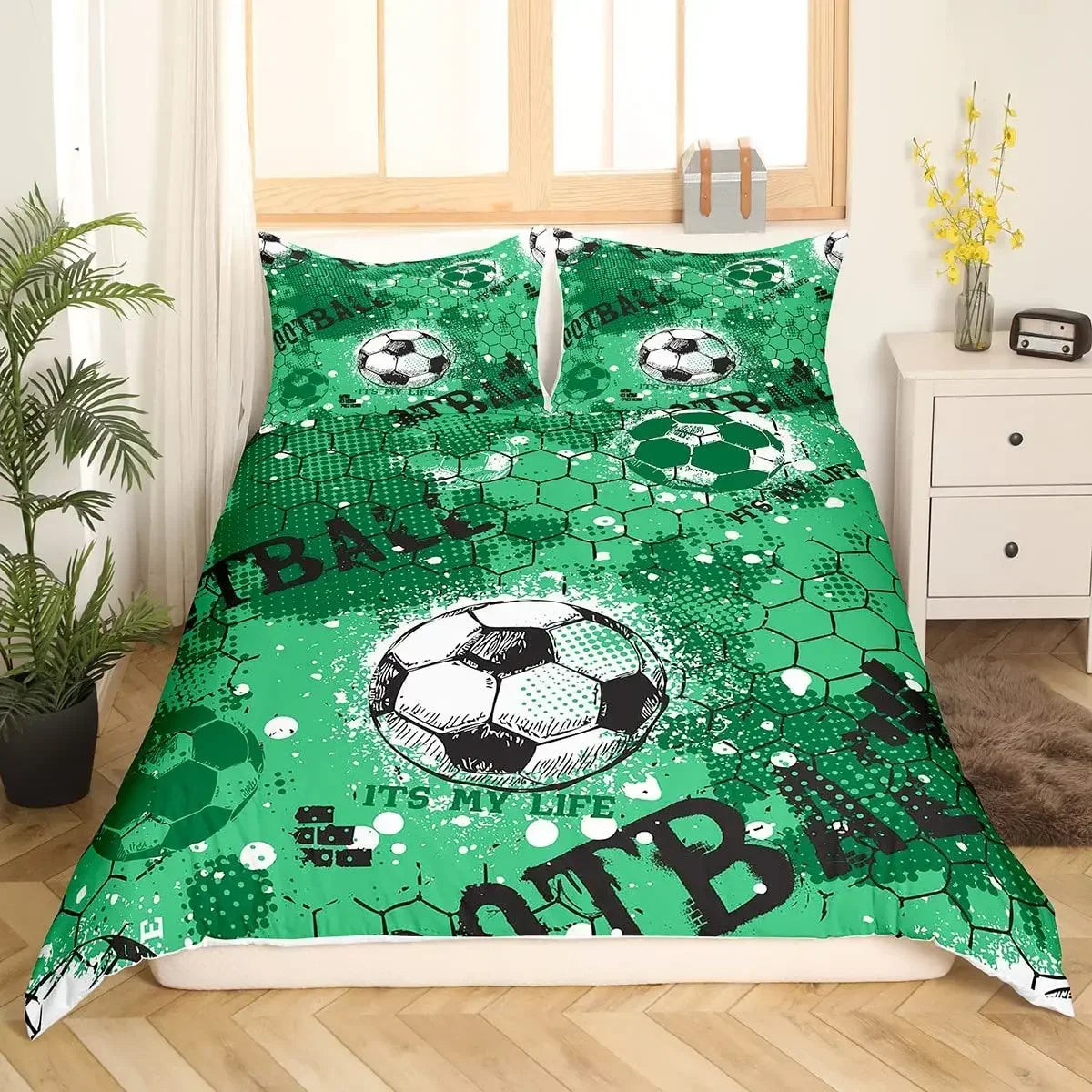 A green duvet cover featuring a soccer ball pattern with the text ATB
