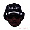 Black embroidered patch featuring a stylized skull design with white text on a black baseball cap background