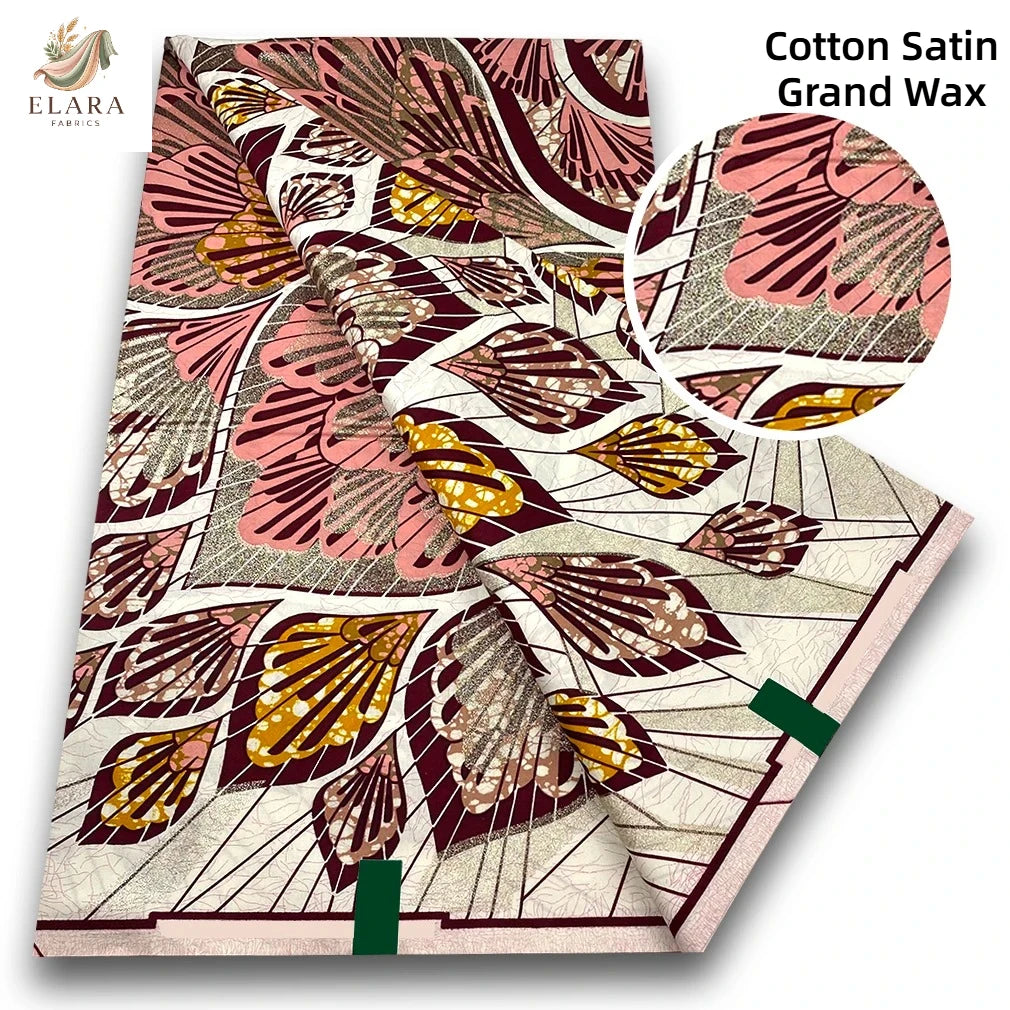 A close-up of Cotton Satin Grand Wax fabric featuring intricate floral patterns in shades of pink, brown, and gold.