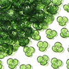Green resin flower bead caps scattered on a white background for jewelry making