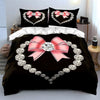 Black bedding set featuring a diamond heart print with pink satin bows and silver diamond accents