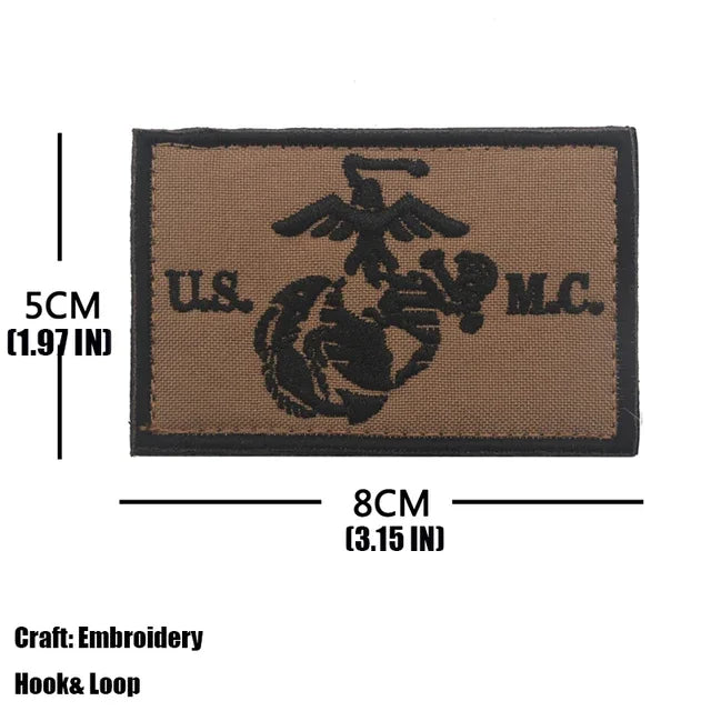 A rectangular brown embroidered patch featuring the U.S. Marine Corps emblem.