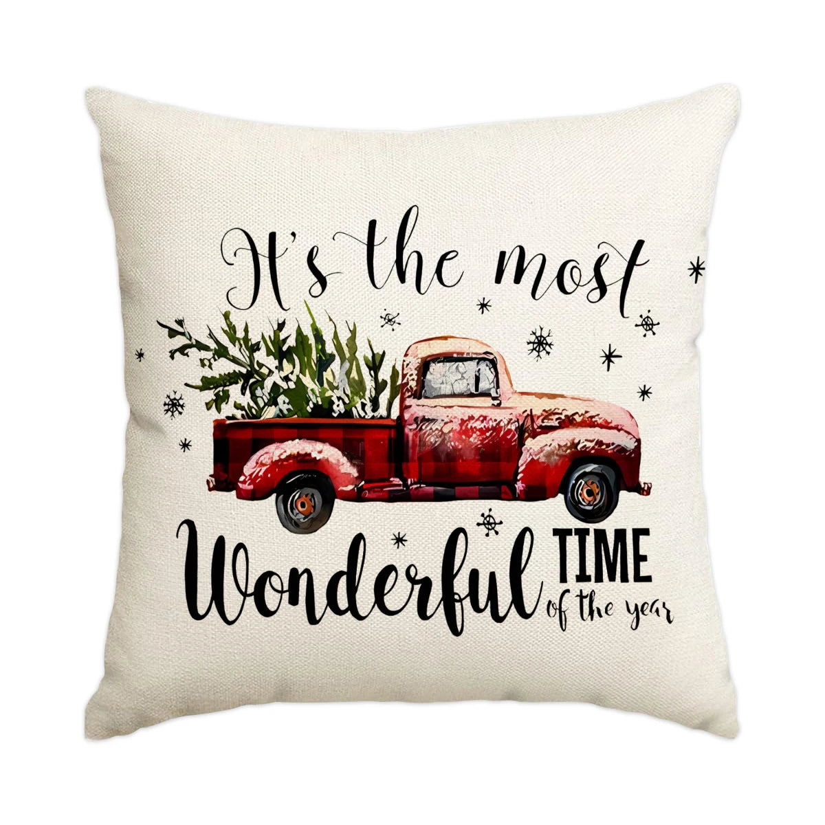 A cream-colored pillow featuring text that reads It's the most wonderful time of the year with a vintage red pickup truck ill