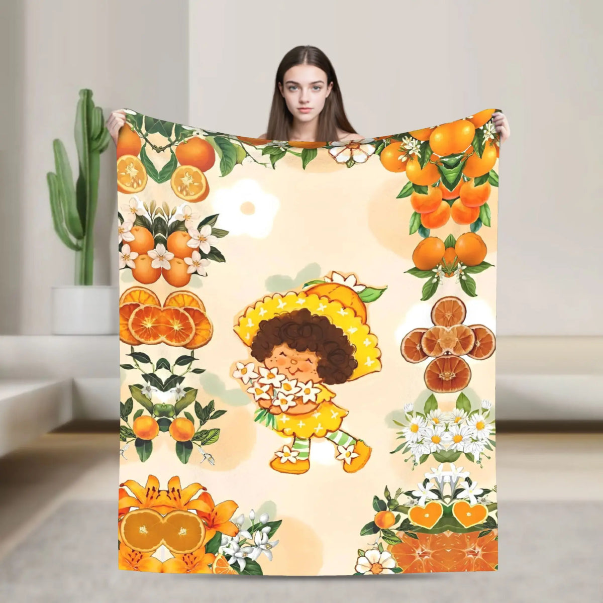 A plush throw blanket featuring a colorful illustration of Strawberry Shortcake and citrus fruits.