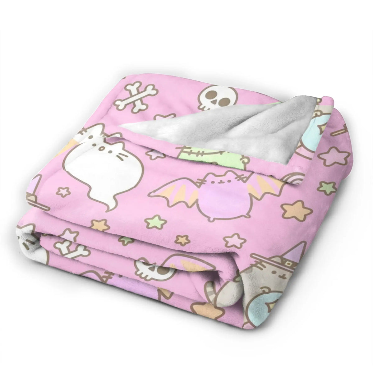 A pink coral fleece blanket featuring a pattern of cute cats, skulls, and stars.