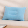 A light blue inflatable travel neck pillow resting on a surface.