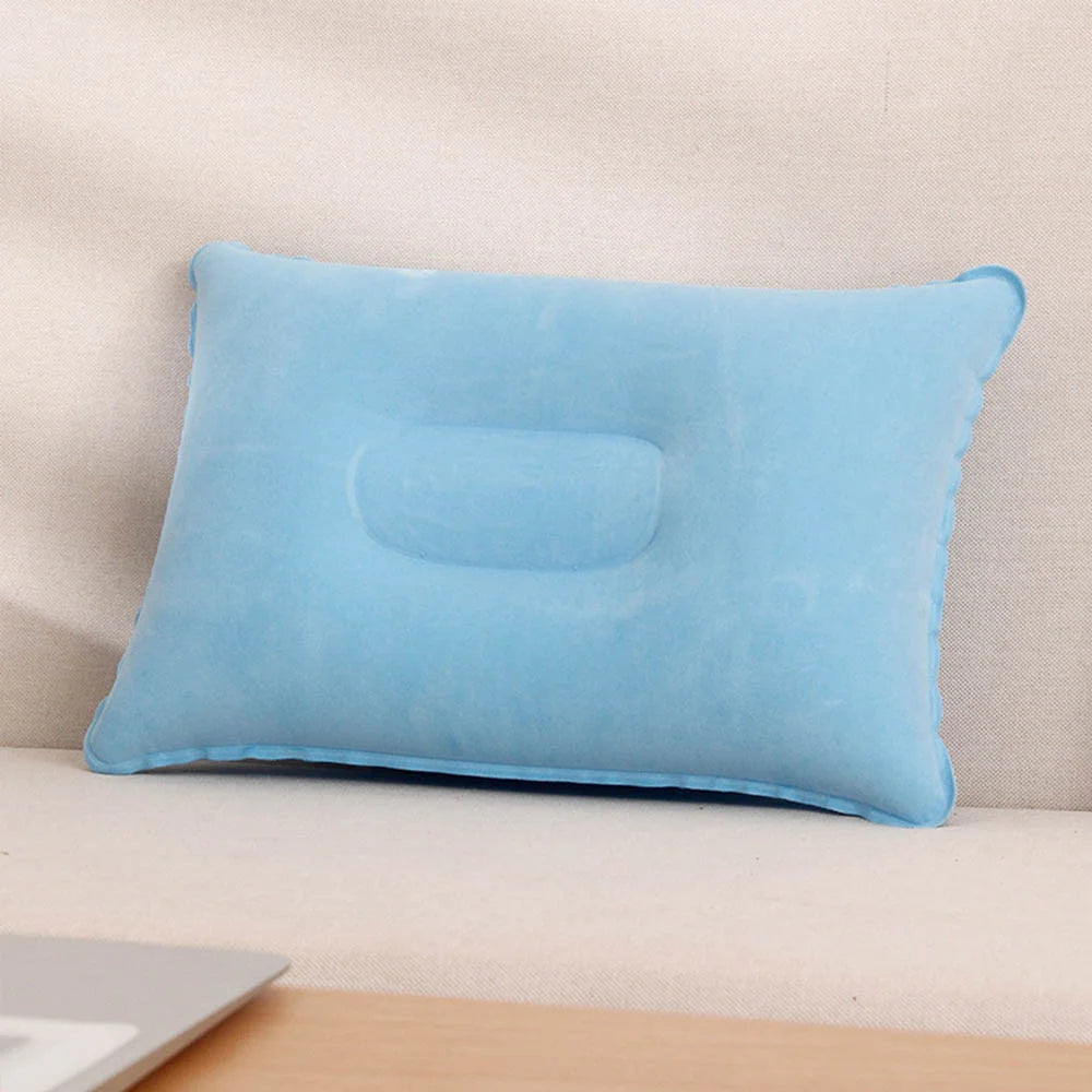 A light blue inflatable travel neck pillow resting on a surface.