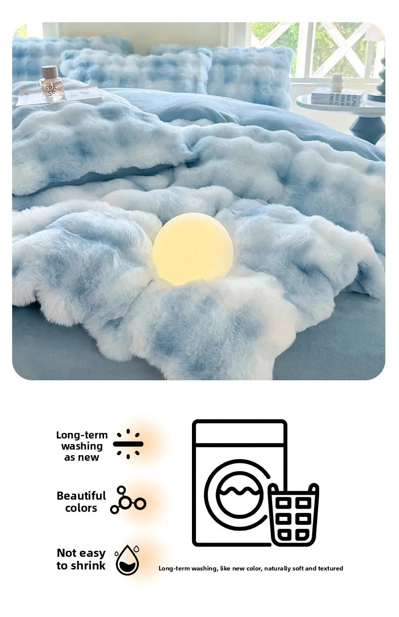 A light blue fluffy fleece duvet cover with a rabbit design shown on a bed.