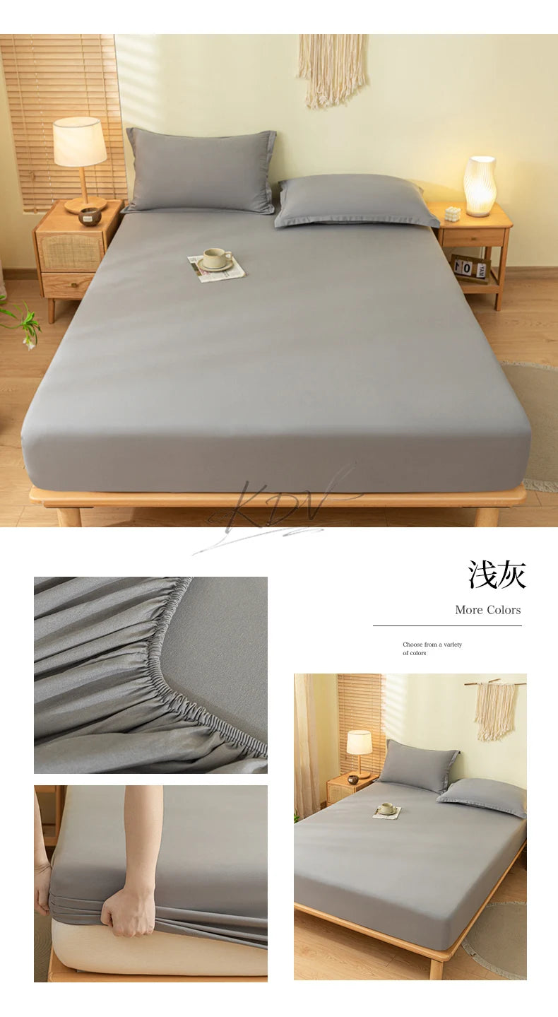 A gray fitted sheet set with pillowcases displayed on a wooden bed frame in a bright bedroom setting.