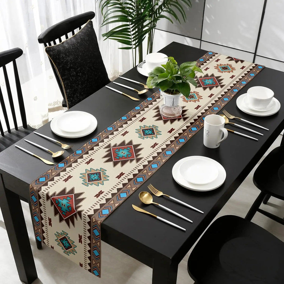 A black dining table set with a bohemian linen table runner featuring an Indian-inspired geometric print.
