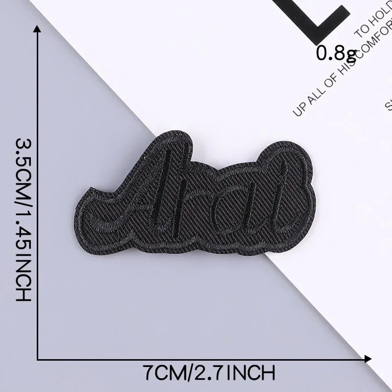 A set of five black embroidered leather patches with self-adhesive backing shown on a white surface.