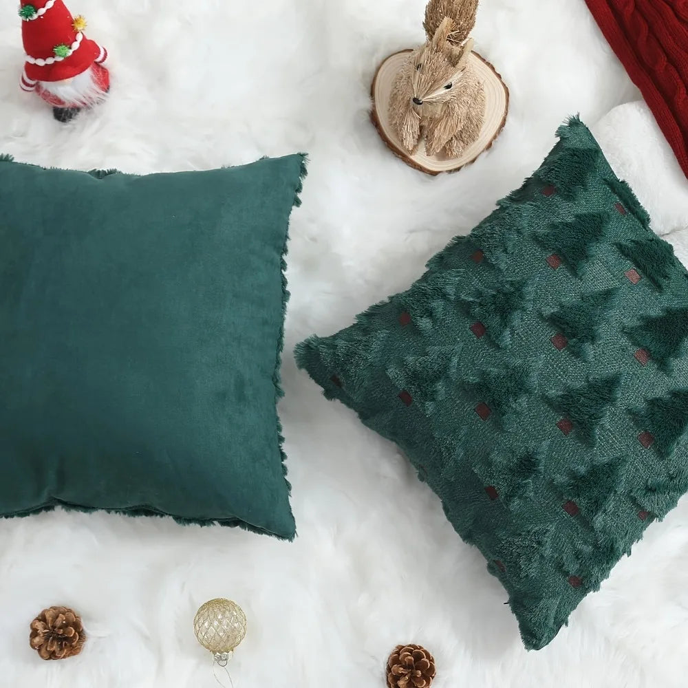 A teal velvet throw pillow with a green patterned cover rests on white faux fur with festive holiday decor.