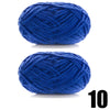 A ball of thick, navy blue velvet yarn used for knitting and crochet projects.