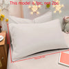 A white matte solid color pillowcase is shown on a bed with decorative star lights in the background.