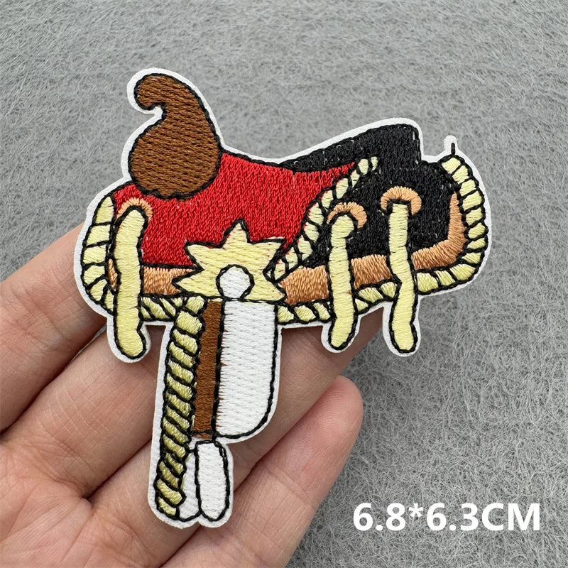 Embroidered iron-on patch featuring a stylized brown and red cowboy figure with a star design