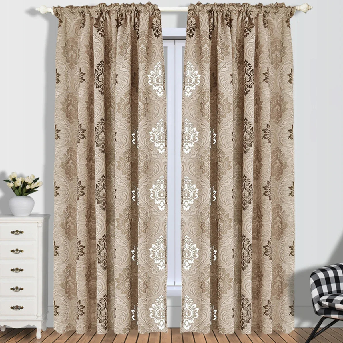 A pair of beige sheer jacquard curtain panels hanging in a white frame against a light wall.