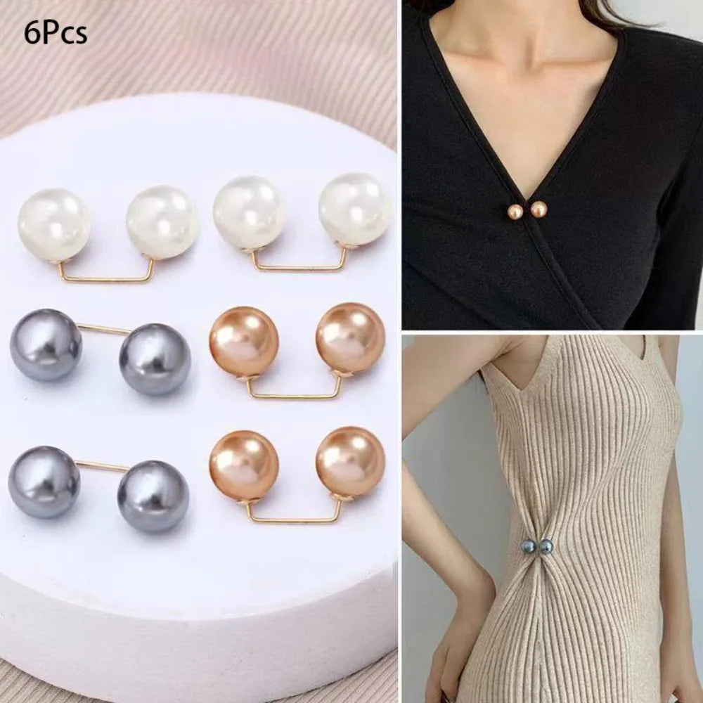 A set of six pearl brooch jewelry pieces in various shades of white and silver on a white background.
