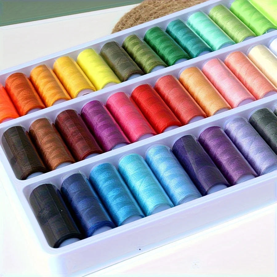 A collection of 39 colored sewing threads in various shades arranged in a white storage box.