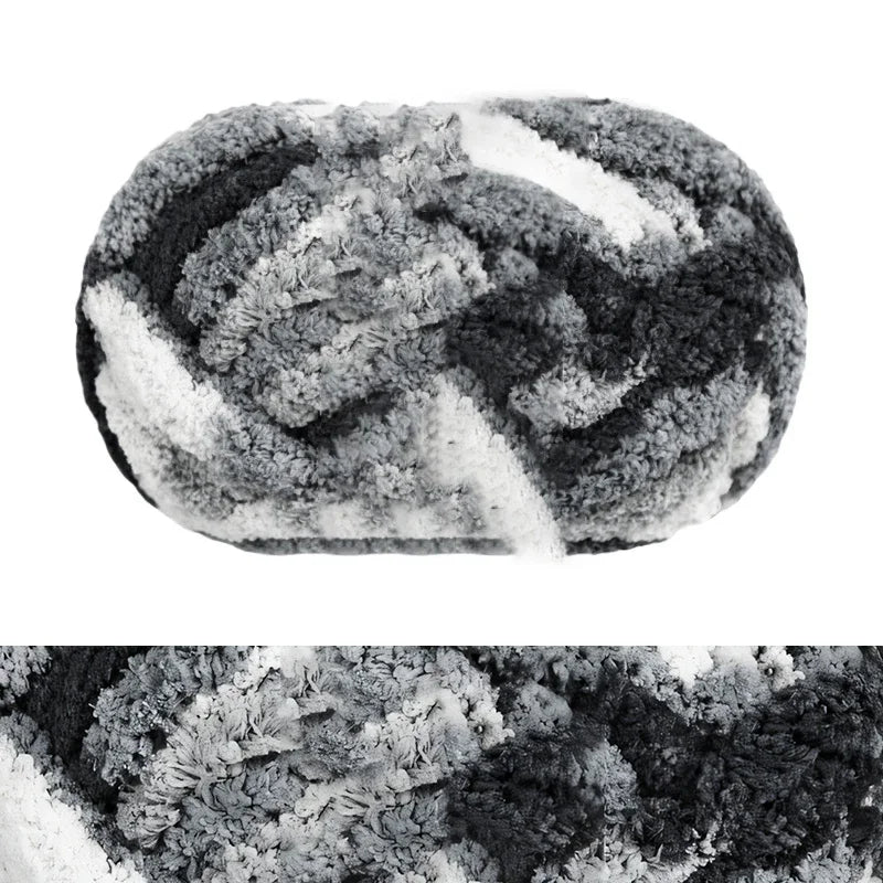 A hand-knitted wool finger line scarf with a mottled black and white pattern.
