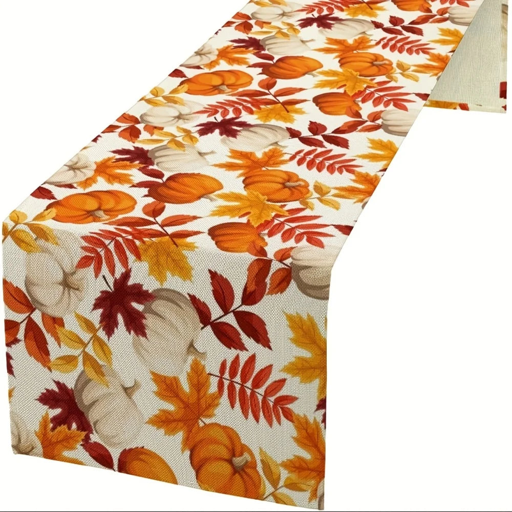 Autumn fall leaves table runner featuring orange and yellow leaves and white pumpkins
