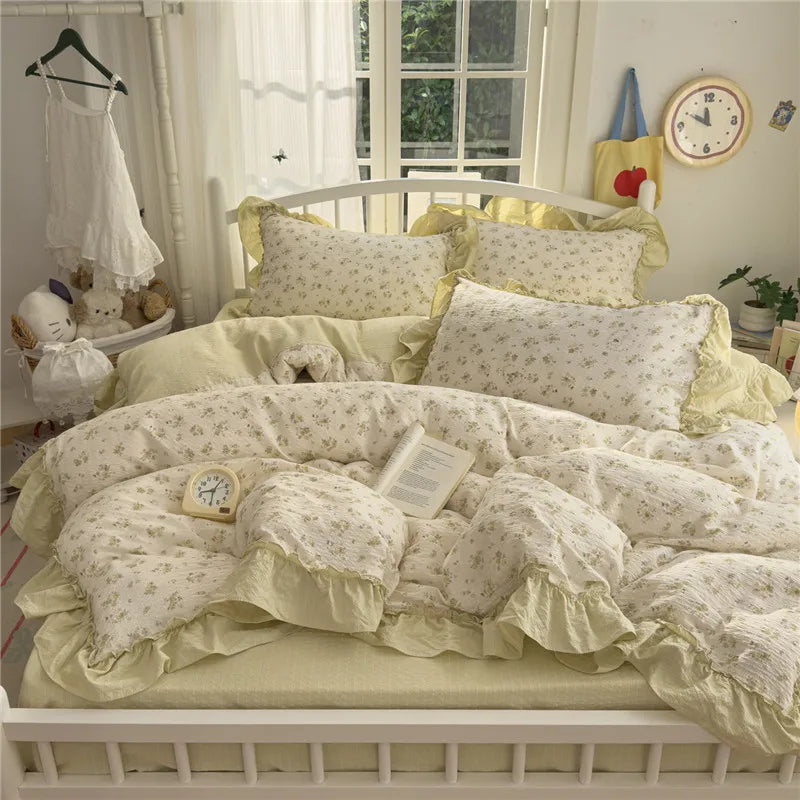 A princess style bedding set featuring light yellow and white floral patterned sheets and pillows on a white bed frame.