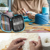 A hand is using a complete crochet needle set for knitting and stitch markers on a piece of yarn.