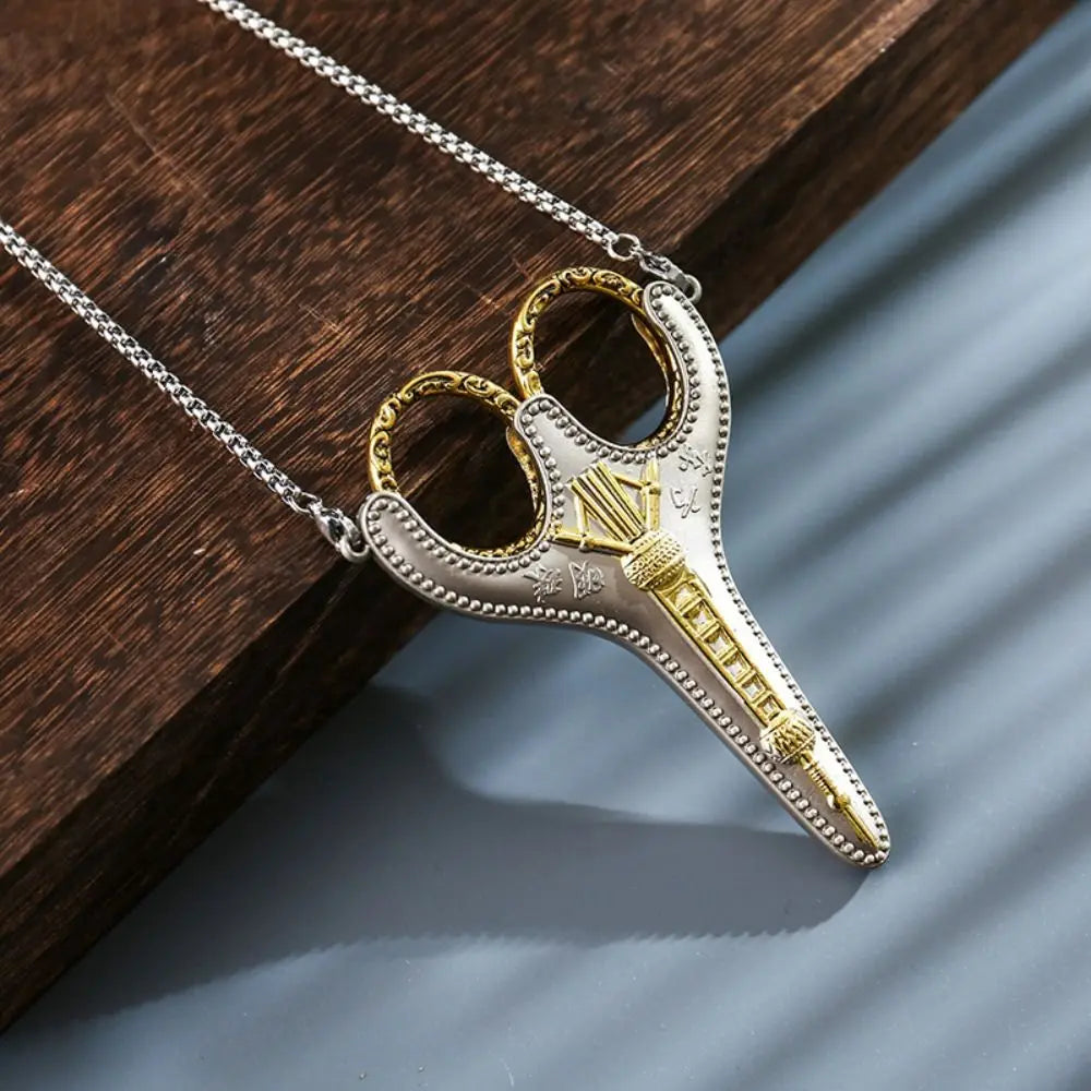 Vintage stainless steel sewing scissors with gold accents displayed on a dark wooden surface.