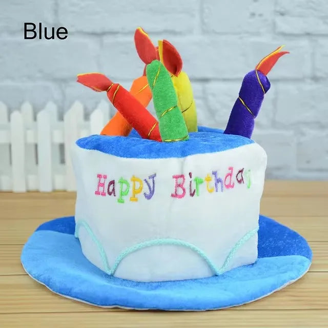 A white birthday cake decorated with blue frosting and a colorful candle hat